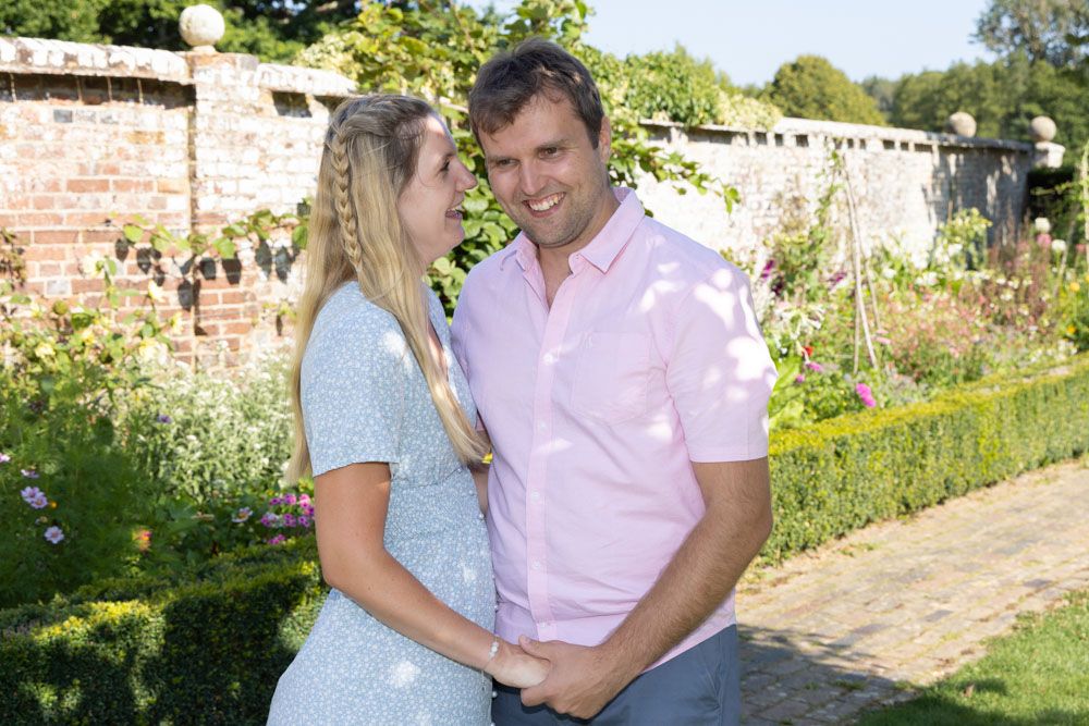 Couple embrace in garden of historic Kent house