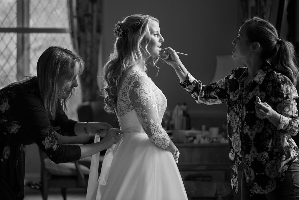 Bride with make up artist and dress maker
