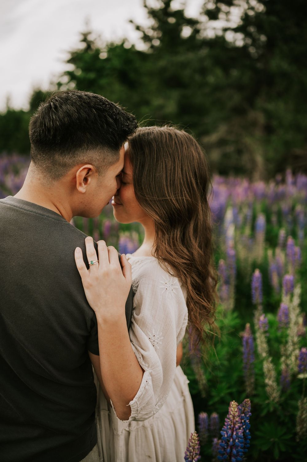 Portrait of couple embracing in lupine field Comox Valley wildflower field locations Photography by Photographer Soulfull Photographs