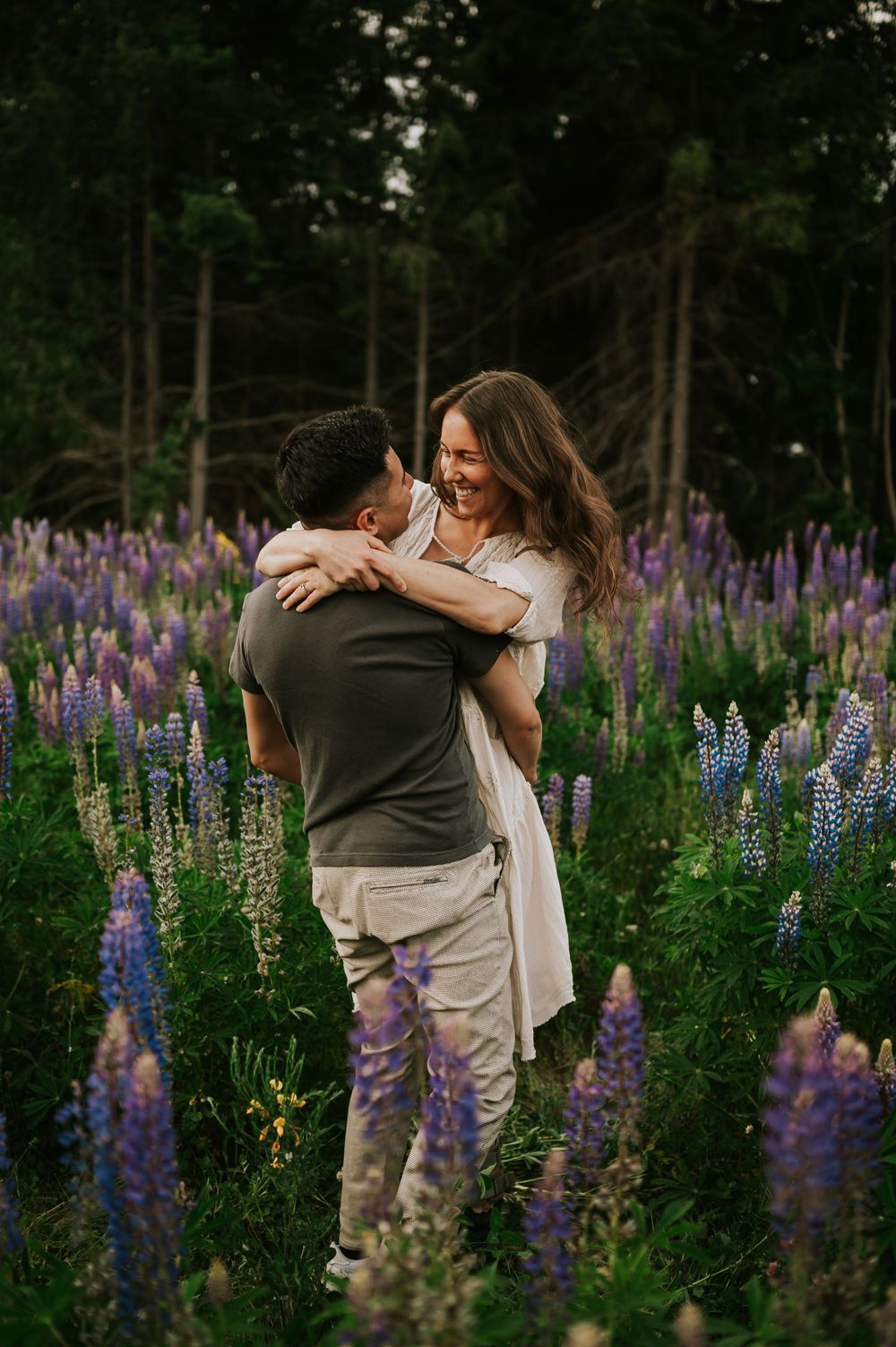 Portrait of couple spinning in lupine field Comox Valley wildflower field locations Photography by Photographer Soulfull Photographs