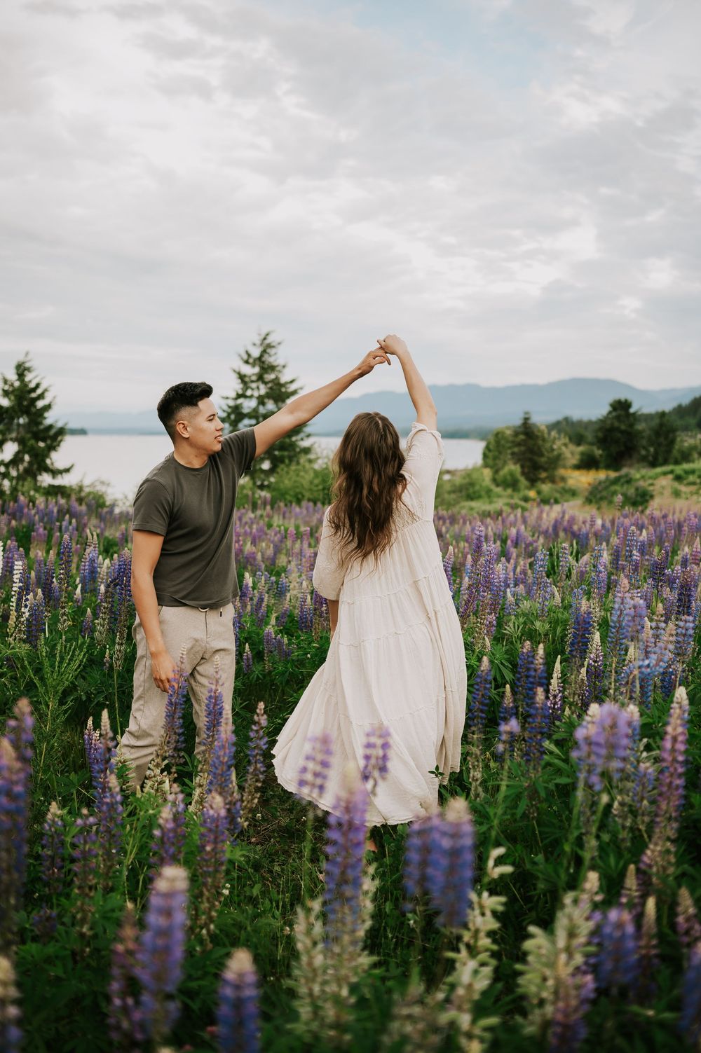 Portrait of couple spinning in lupine field Comox Valley wildflower field locations Photography by Photographer Soulfull Photographs