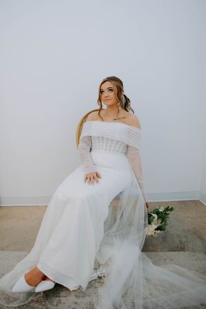 Bridal portrait series featuring an off-shoulder white gown in a bright minimalist setting.