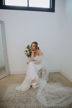 Artistic bridal portraits captured in a modern white room with natural lighting.