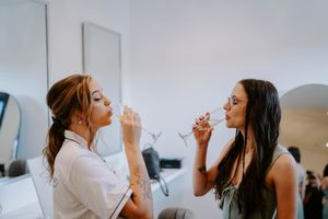 Wedding party members share celebratory moments while getting ready.