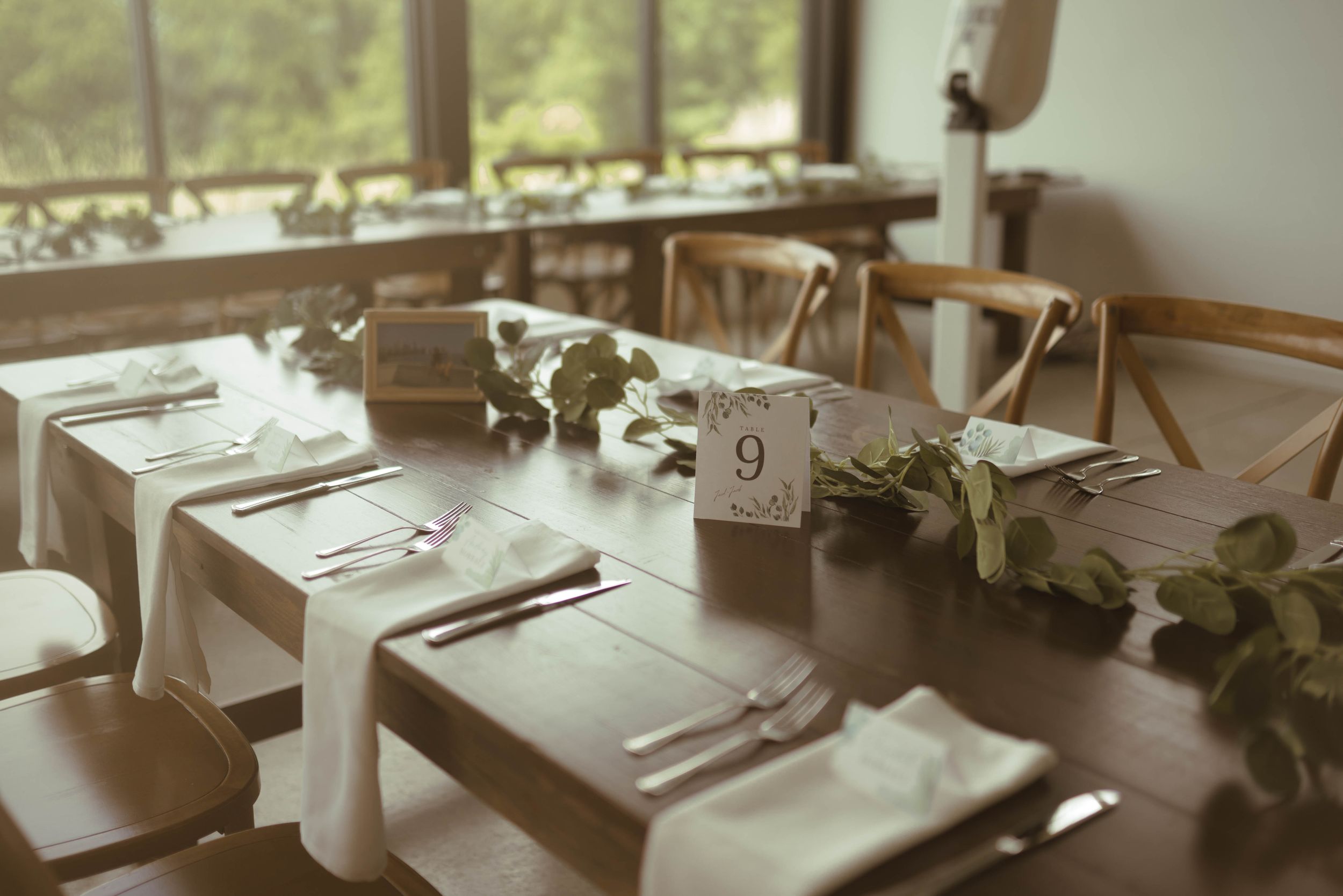 Elegant table settings with natural light streaming through windows.