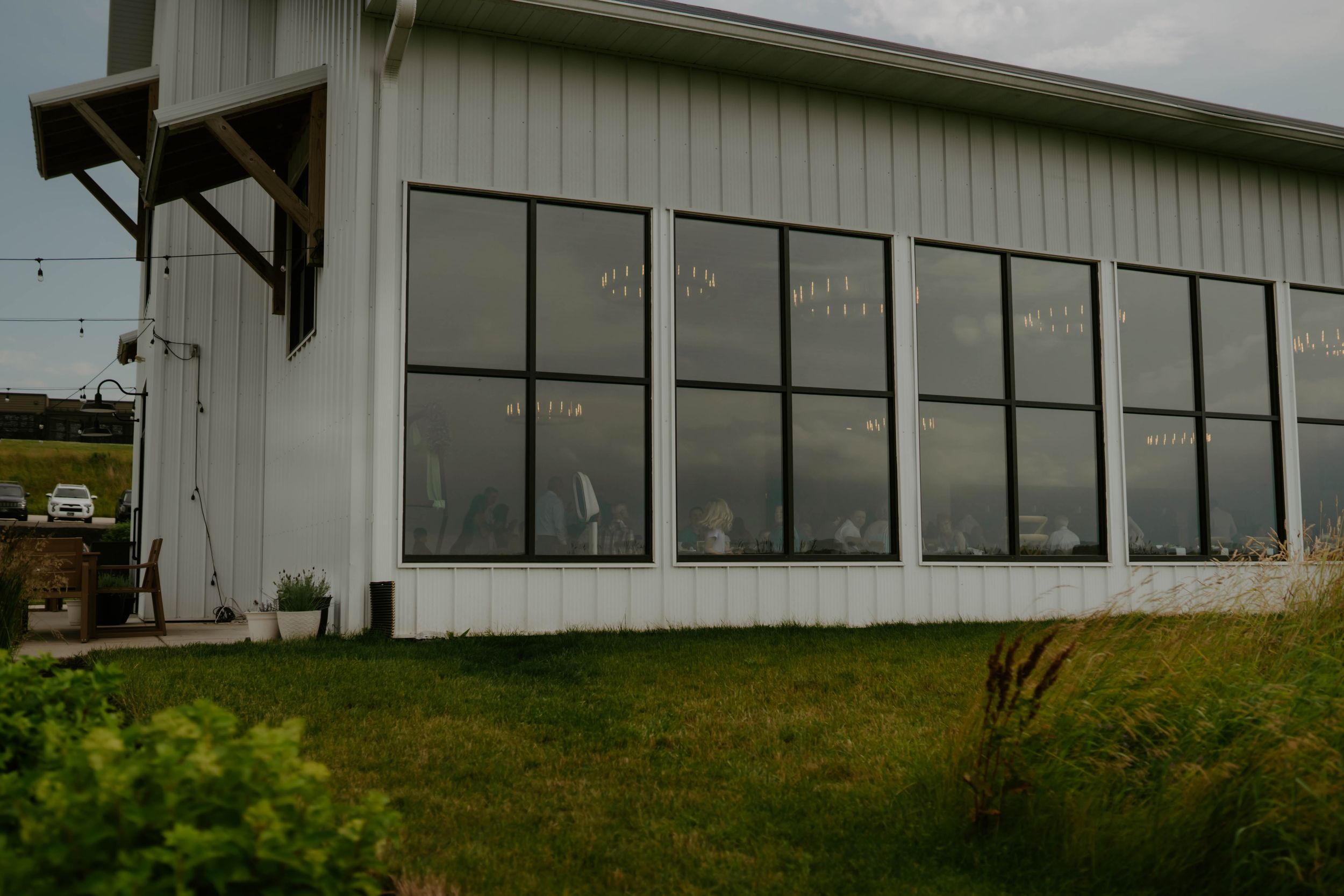 Exterior view of a modern white building with large windows.
