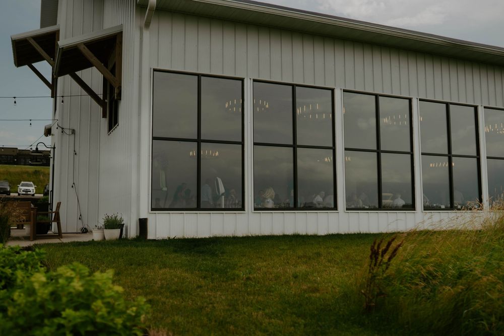 Exterior view of a modern white building with large windows.