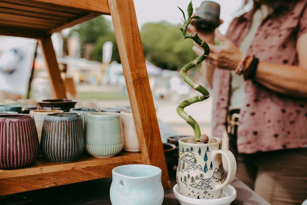 Woman looking at pottery at local market with a planter and bamboo growing out, Whitney Popp photographer