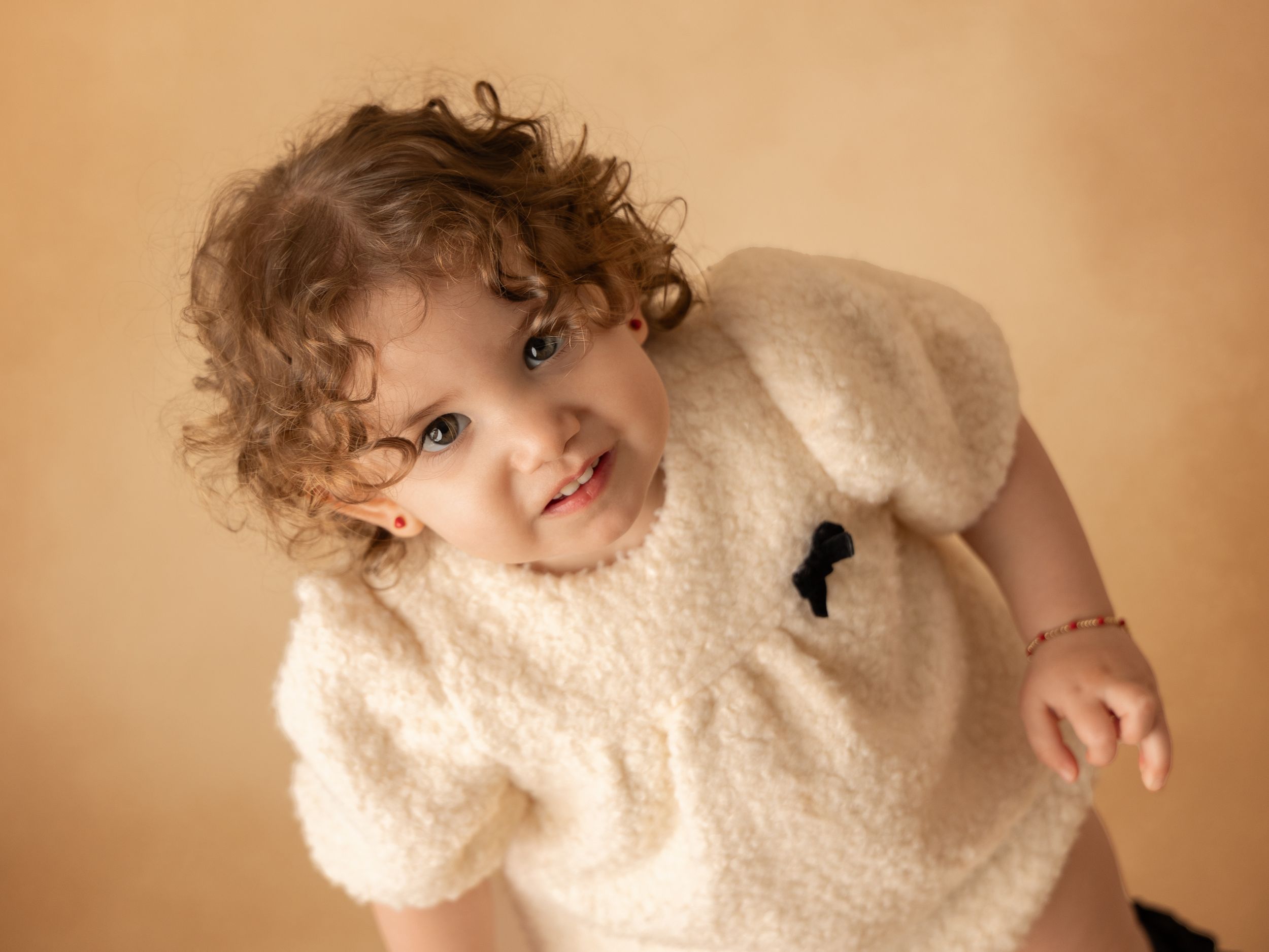 Eight sequential photos show someone wearing a cozy cream sherpa fleece hoodie in various casual poses.