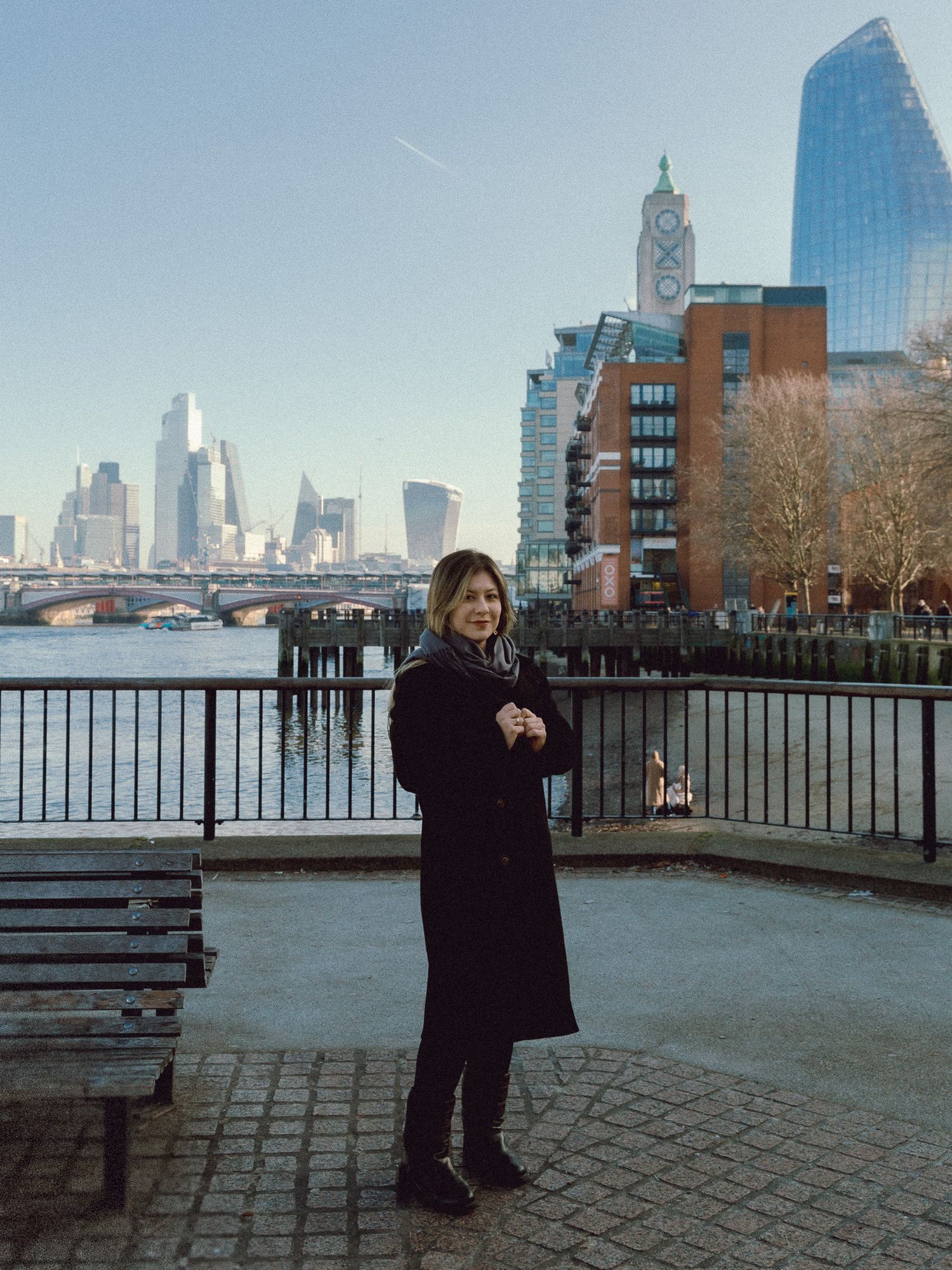 A winter scene along the Thames River with London's modern skyline in the background.
