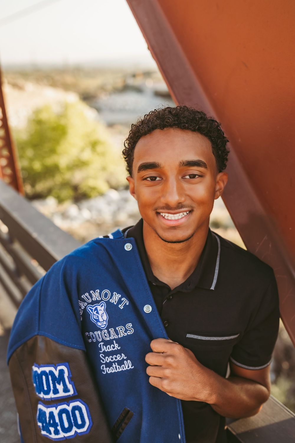 Student athlete in blue letterman jacket shown in multiple poses smiling at camera outdoors.