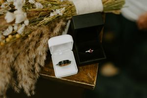 Wedding rings displayed in elegant white boxes with natural lighting.