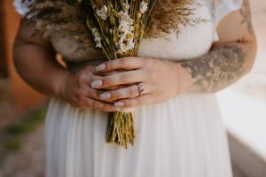 Close-up details of a rustic wedding bouquet with dried flowers and natural elements.