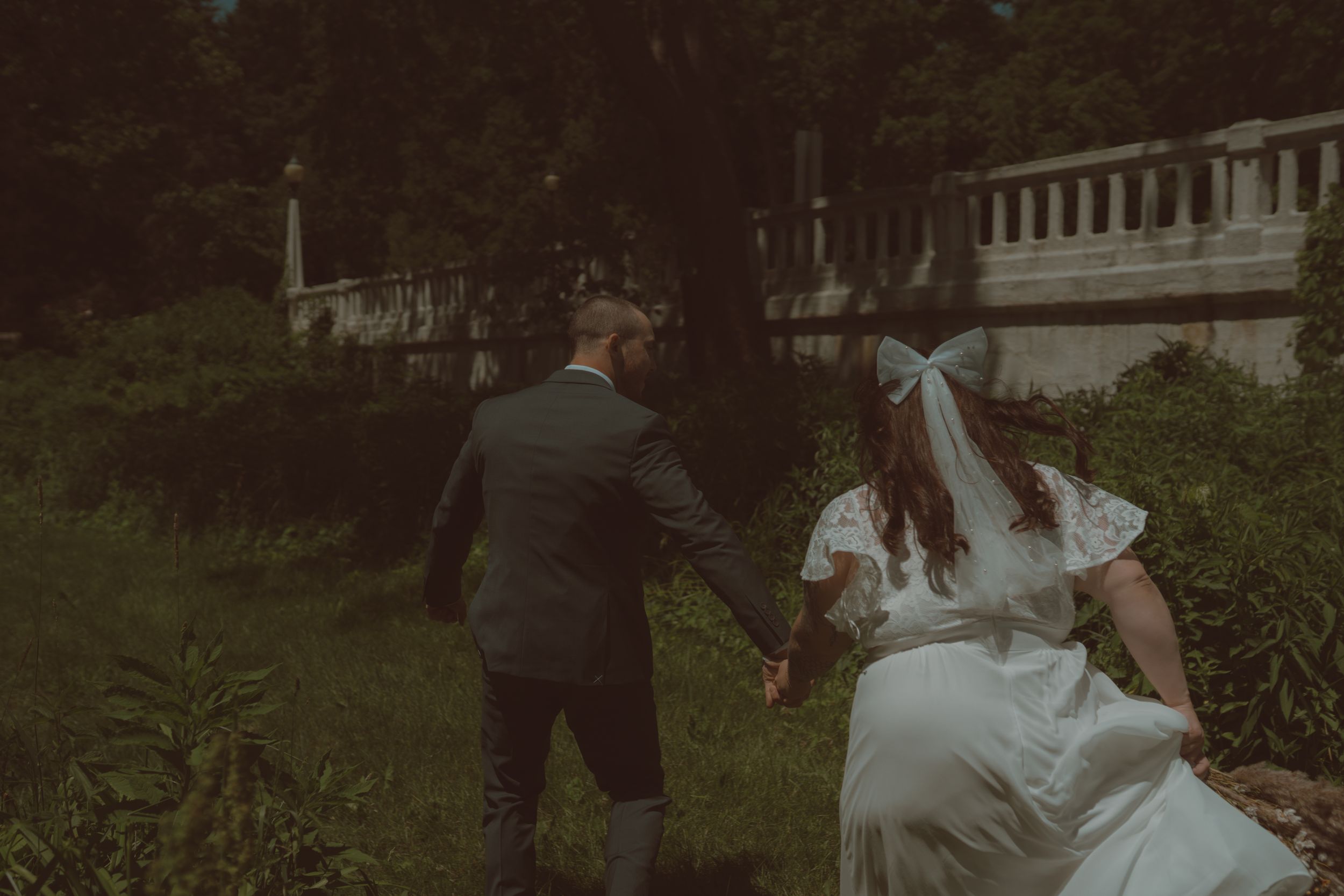 Outdoor wedding photography session with natural greenery and soft lighting.
