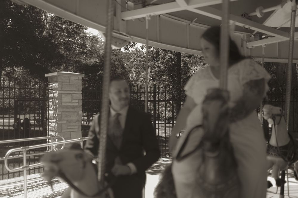 Carousel wedding photo session with vintage-style black and white photography.