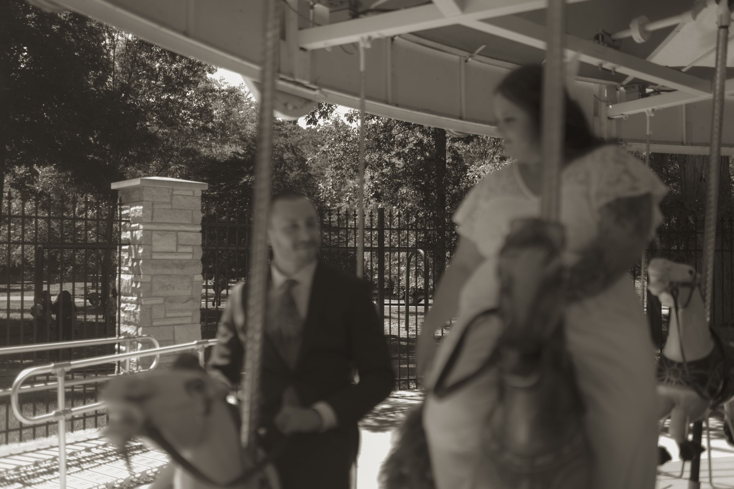 Carousel wedding photo session with vintage-style black and white photography.