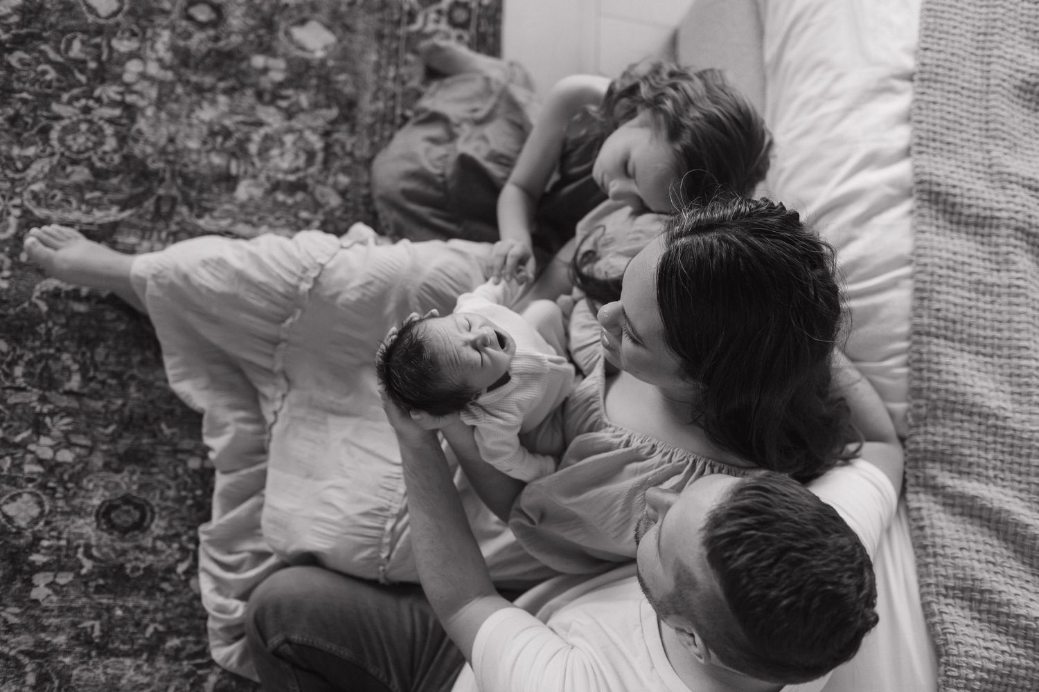 Black and white family portrait showing the family from above
