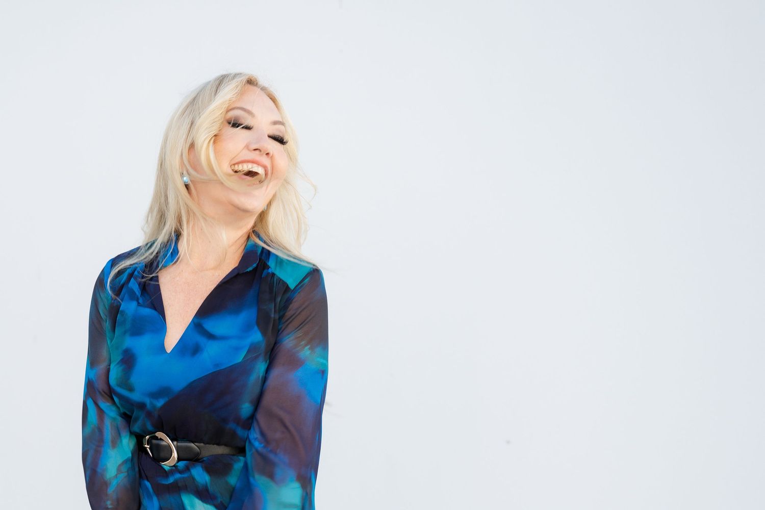 Confident branding portrait of a woman in a vibrant blue dress - natural, personality-driven brand photography for women in business, Tweed