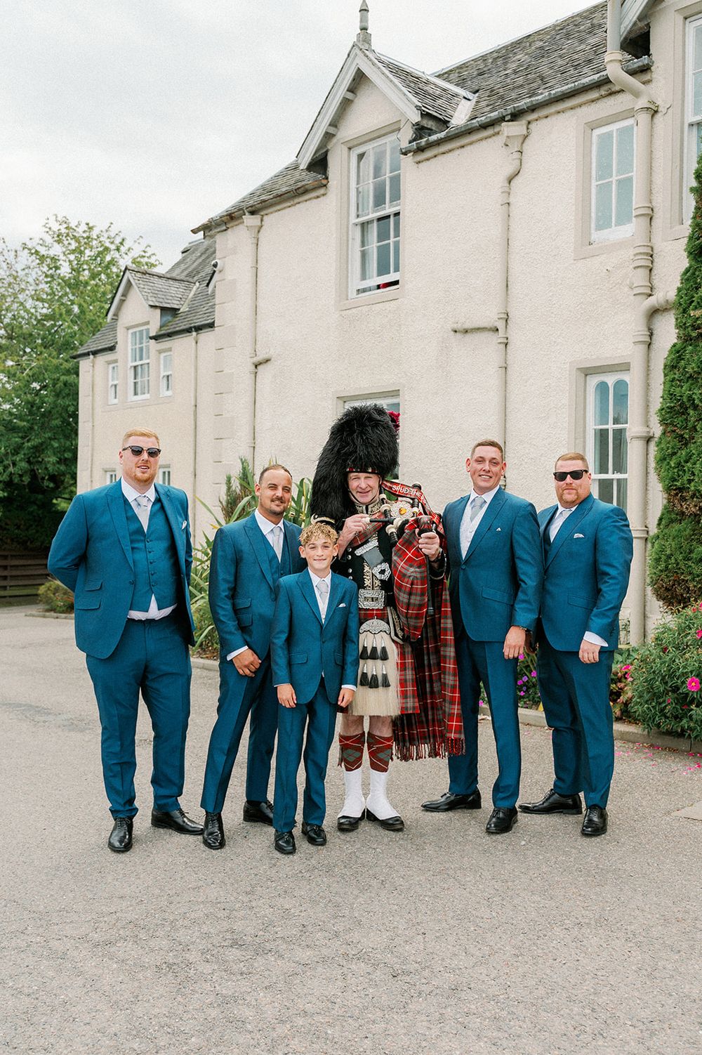 Inverness Wedding Photographer Captures Groomsmen with Spud the Piper