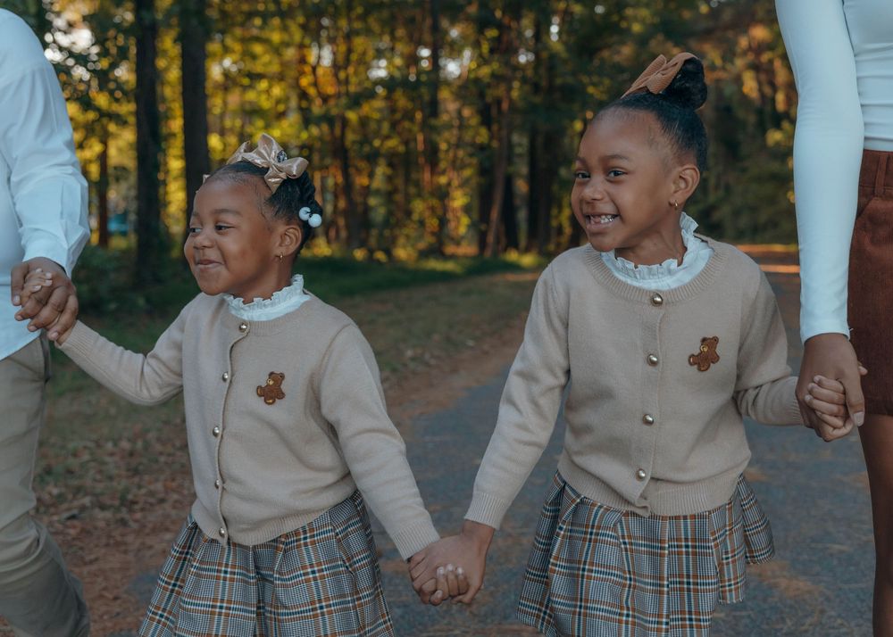 Sisters laughing during a natural light sibling photography session in North Carolina.