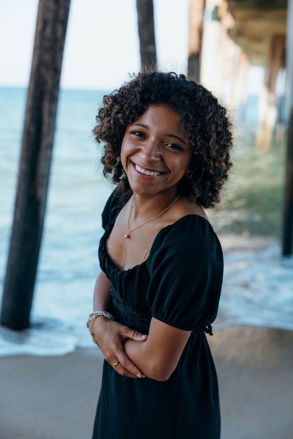 High school senior standing on the beach during a golden hour senior portrait session in the Outer Banks, North Carolina.