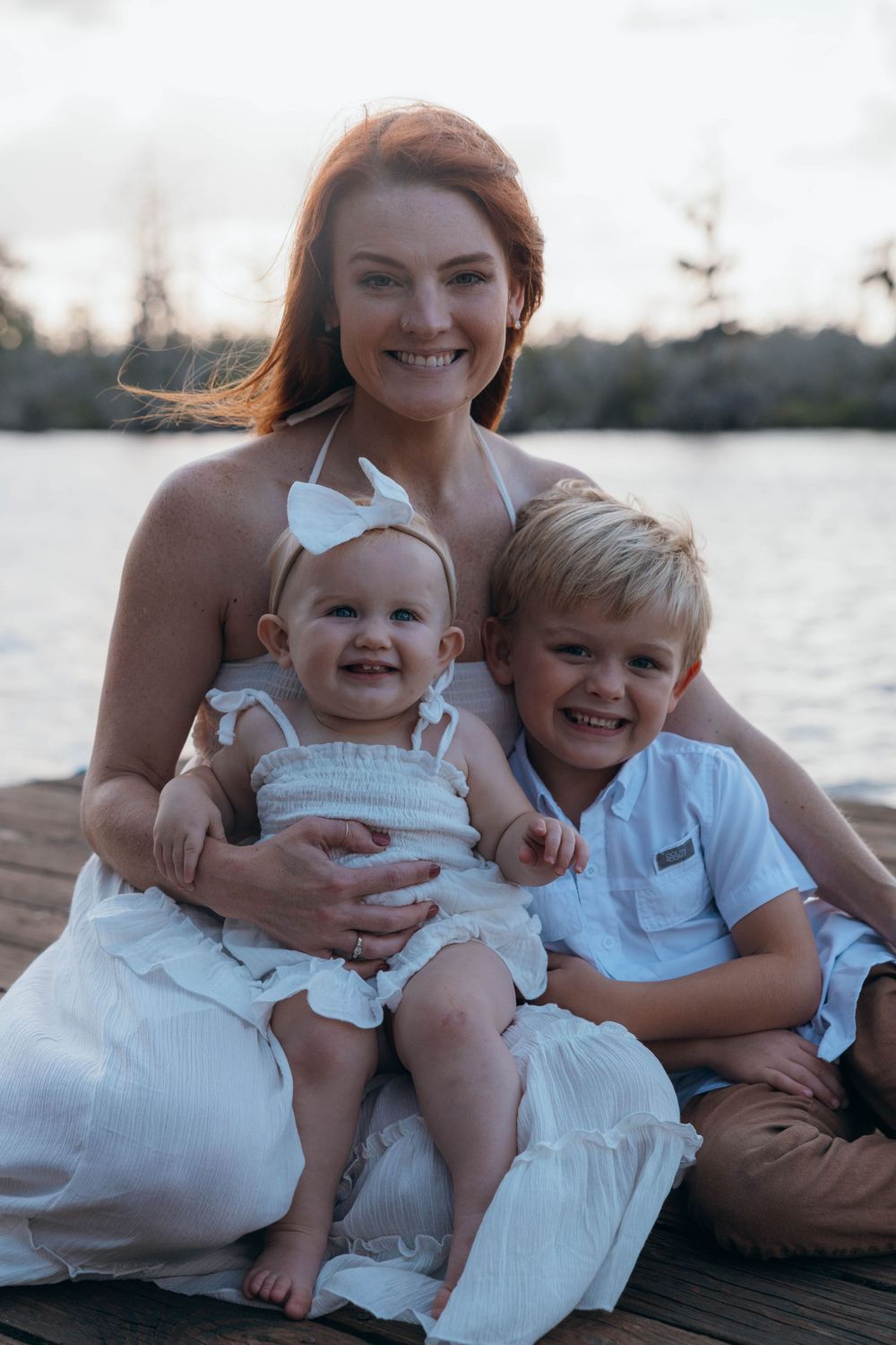 Happy family smiling together during a relaxed outdoor family photography session in North Carolina.