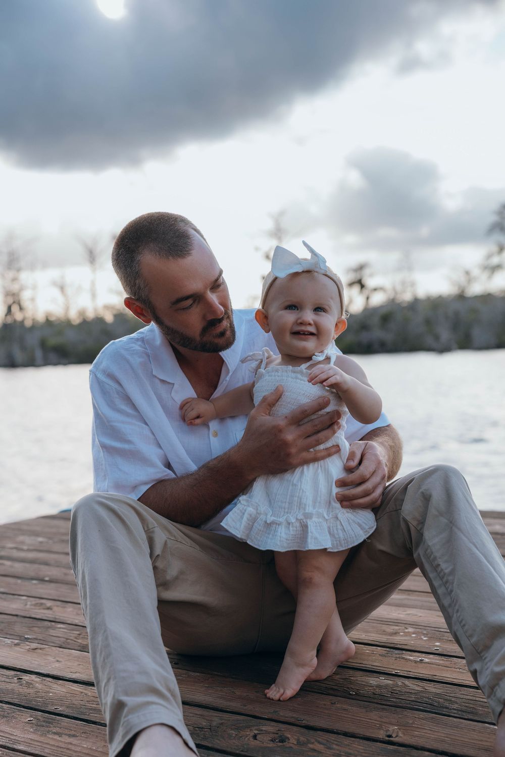 Happy family smiling together during a relaxed outdoor family photography session in North Carolina.