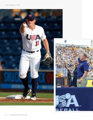 USA Baseball player number 11 pointing on field beside Andrew Vaughn receiving award at ceremony.