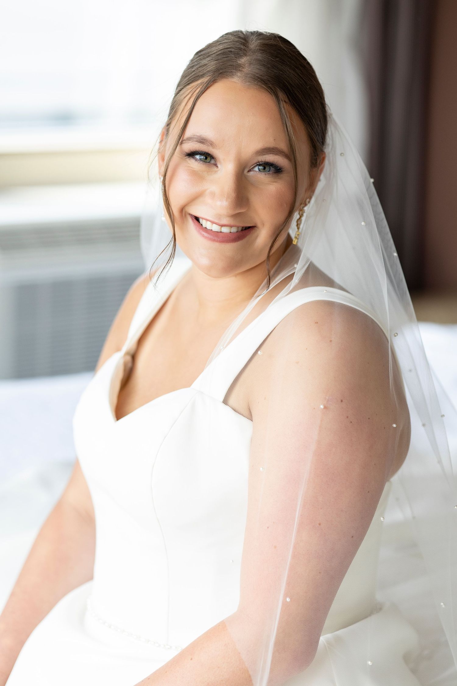 Bride getting ready for wedding at Alerus Center in Grand Forks, North Dakota