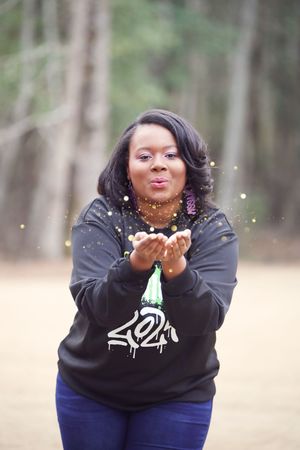 A sequence of joyful photos showing someone in a black sweatshirt blowing glitter from their hands in an outdoor setting.