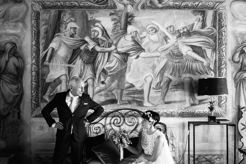 Detail of classical fresco paintings with ornate decorative artwork and architectural elements in black and white.