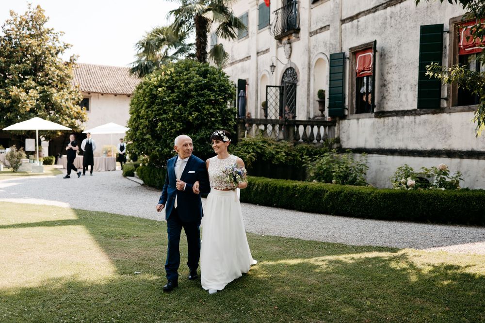Wedding ceremony at an elegant historic venue with manicured garden grounds.