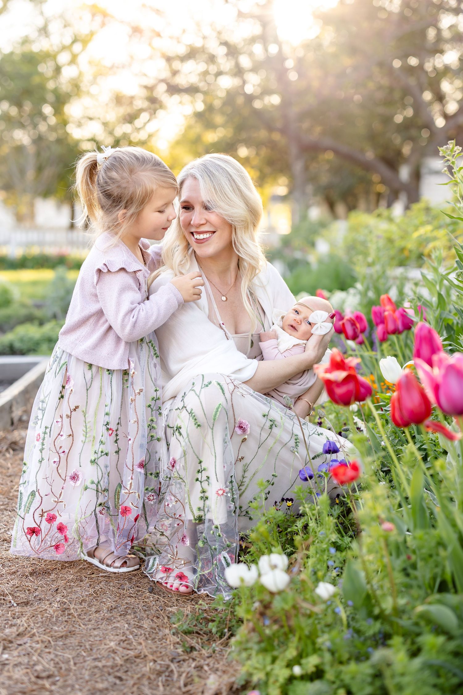 Sample gallery of family photography with a newborn in a Colonial Williamsburg tulip garden.