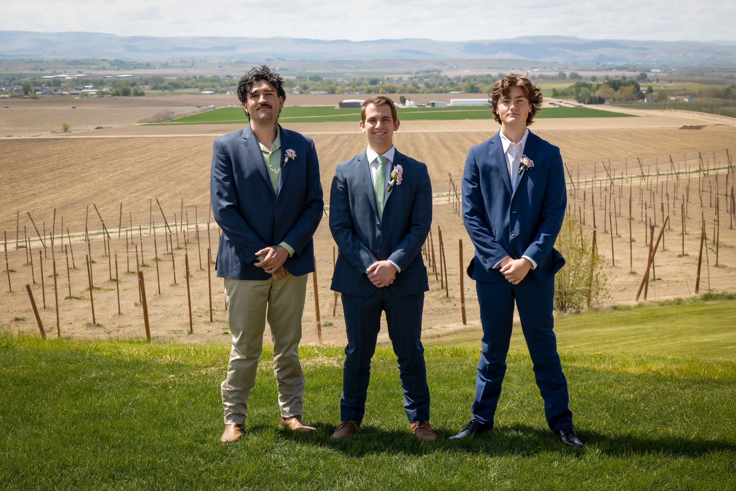 Groom with groomsmen wearing blue and tan for spring styled wedding