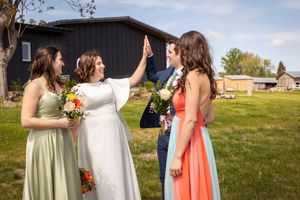 Bride and groom giving a high 5