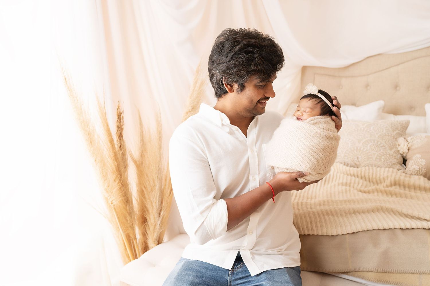 Studio portrait session showing tender family moments against white backdrop with natural lighting.