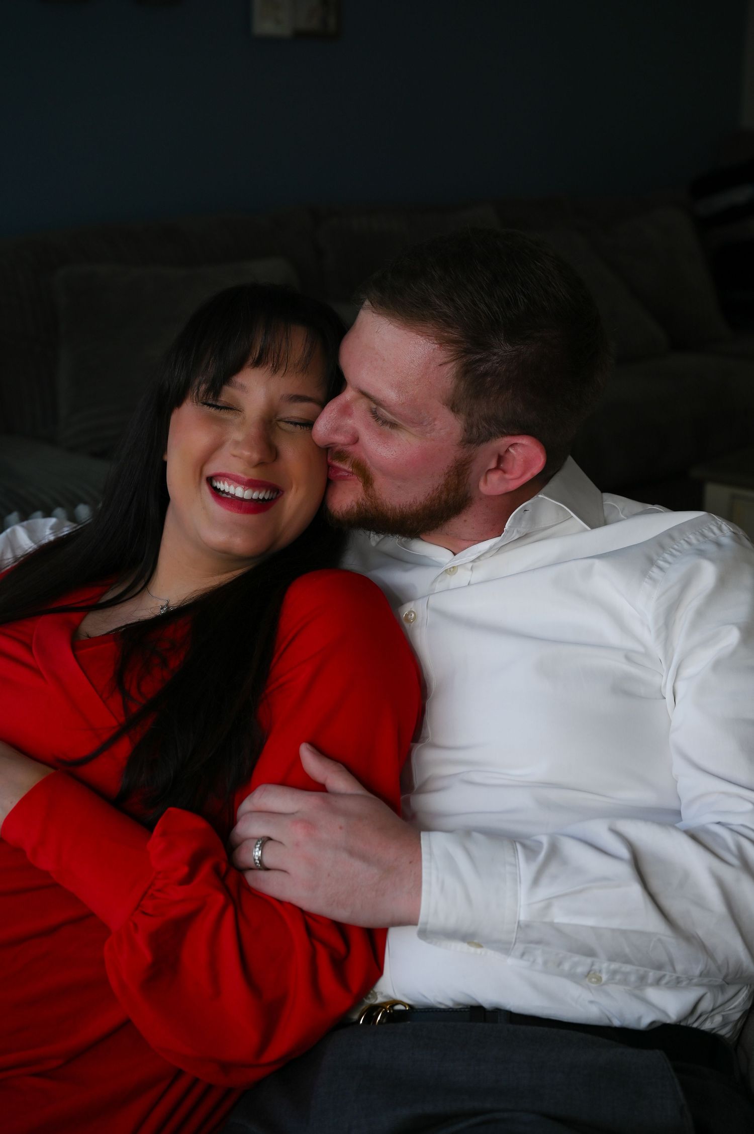 Cozy indoor portrait of couple sharing intimate moment on couch.
