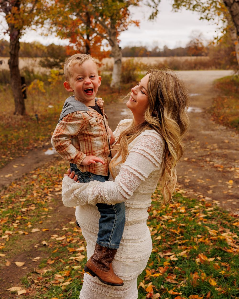 A tender autumn moment captured in a series of photos showing playful interaction amidst fallen leaves in a park setting.