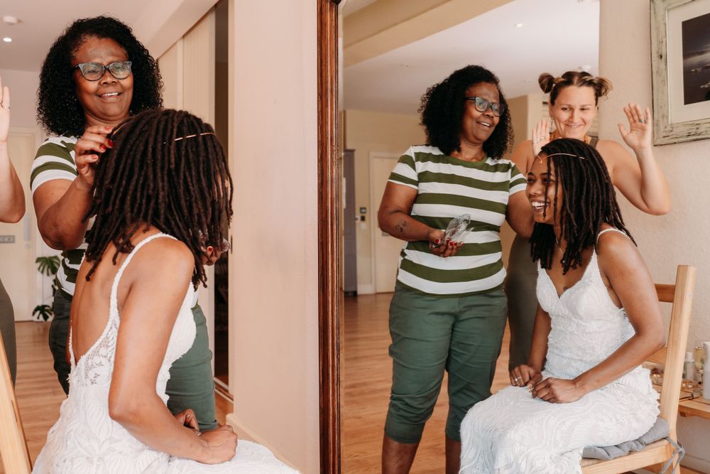 Friends enjoy a light-hearted moment together in a home interior while wearing casual summer outfits.