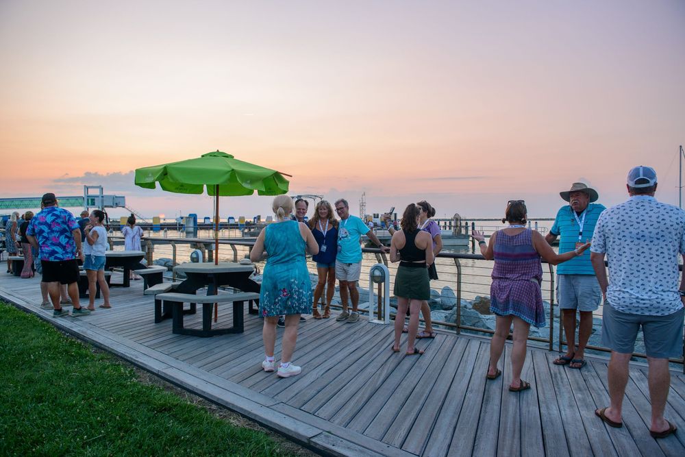 people posing with the sunset in the background