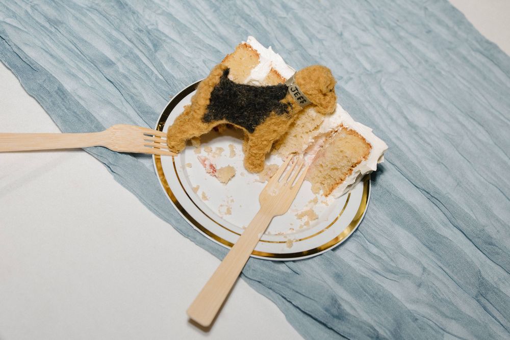 Overhead view of wooden spoons and cutlery on a marble countertop in a kitchen scene.