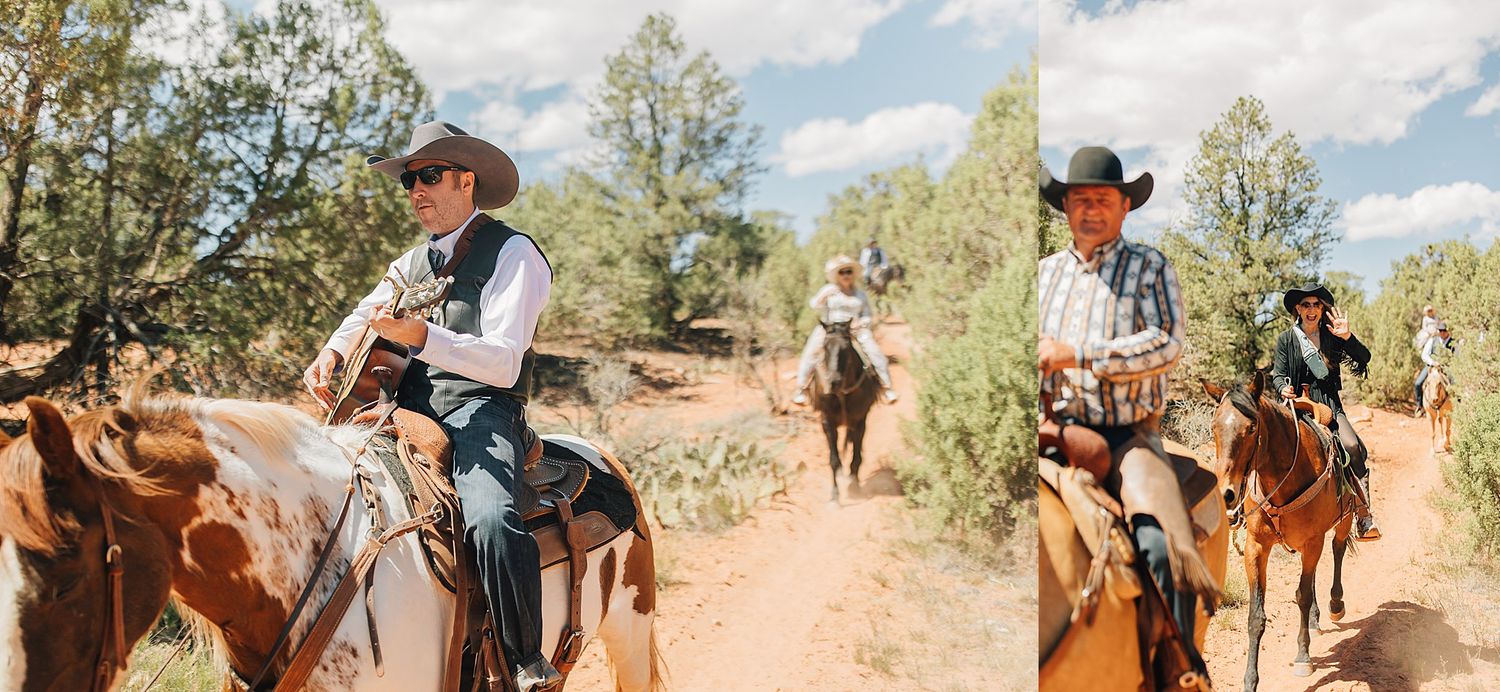 Cowboys ride horses along a dusty trail through a lush forest during a western-themed outdoor wedding celebration.