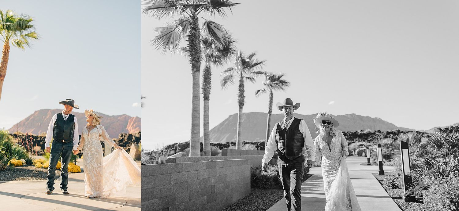 Bride and groom in cowboy hats walk together near palm trees and mountains in a sunny desert wedding setting.