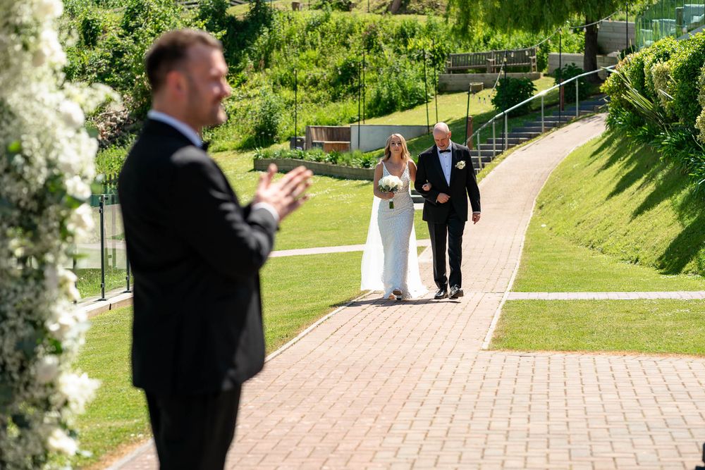 Groom waiting for Bride and father on the outside Isle at Sandy Cove Hotel Wedding