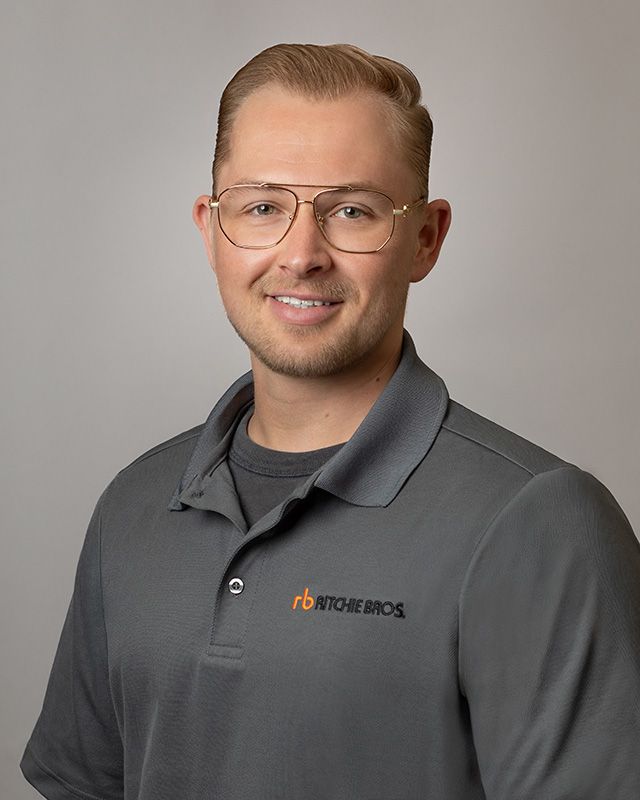 Corporate portrait of Ritchie Bros. Auctioneers sales team member, polished professional look