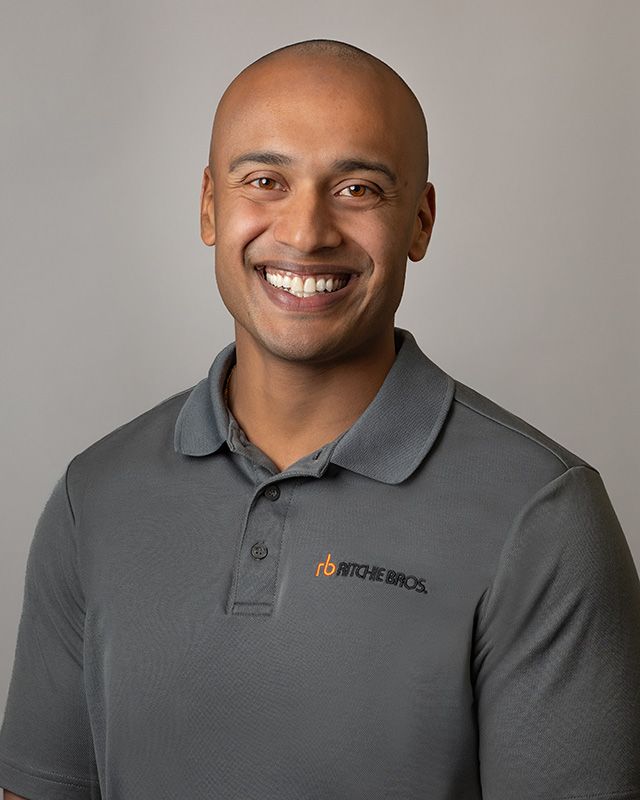 Business headshot of Ritchie Bros. Auctioneers sales representative, confident expression