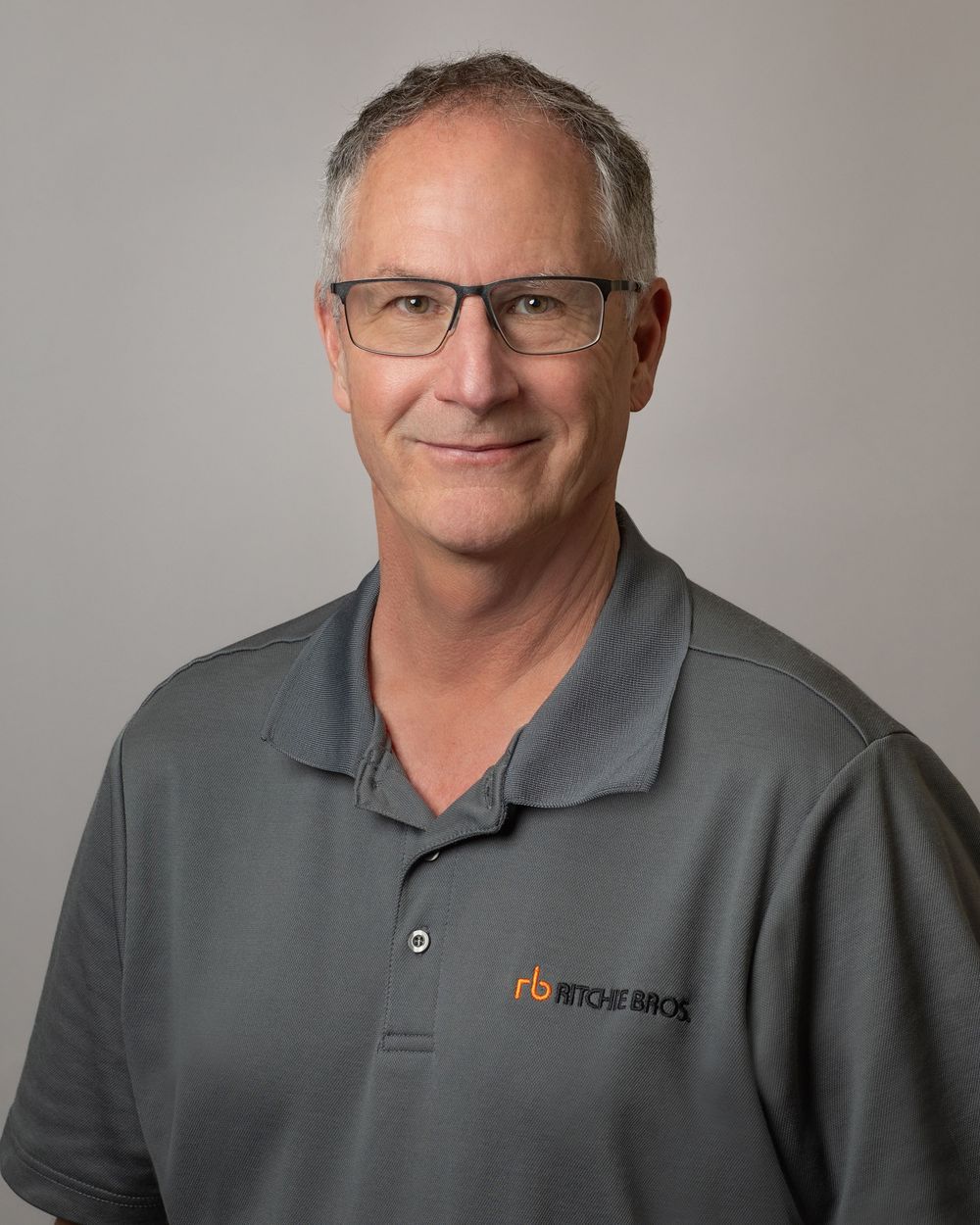 Corporate headshot of sales team member at Ritchie Bros. Auctioneers, neutral studio background.