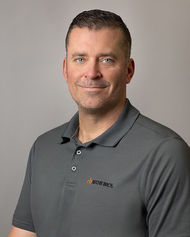Professional corporate headshot for Ritchie Bros. Auctioneers sales team, clean modern lighting