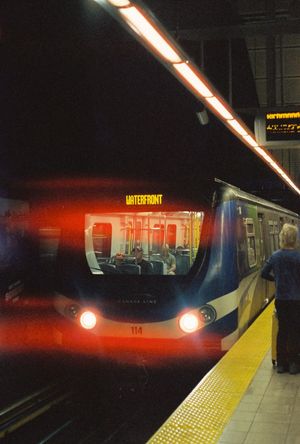 SkyTrain Canada Line car 114 arriving at Waterfront Station platform at night in Vancouver, BC.