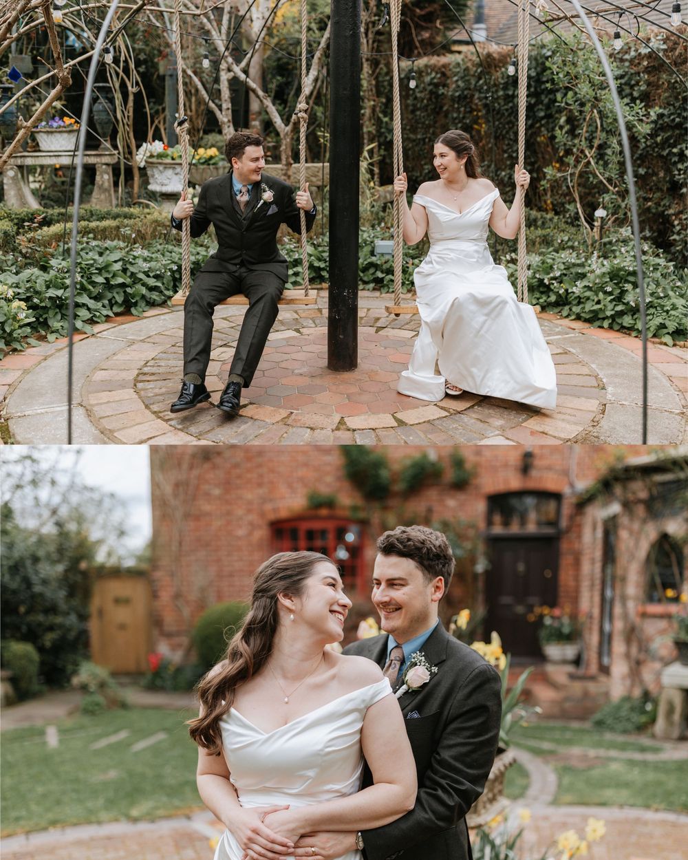 Bride and groom sitting on garden swings and embracing in a lush outdoor wedding venue with brick architecture.